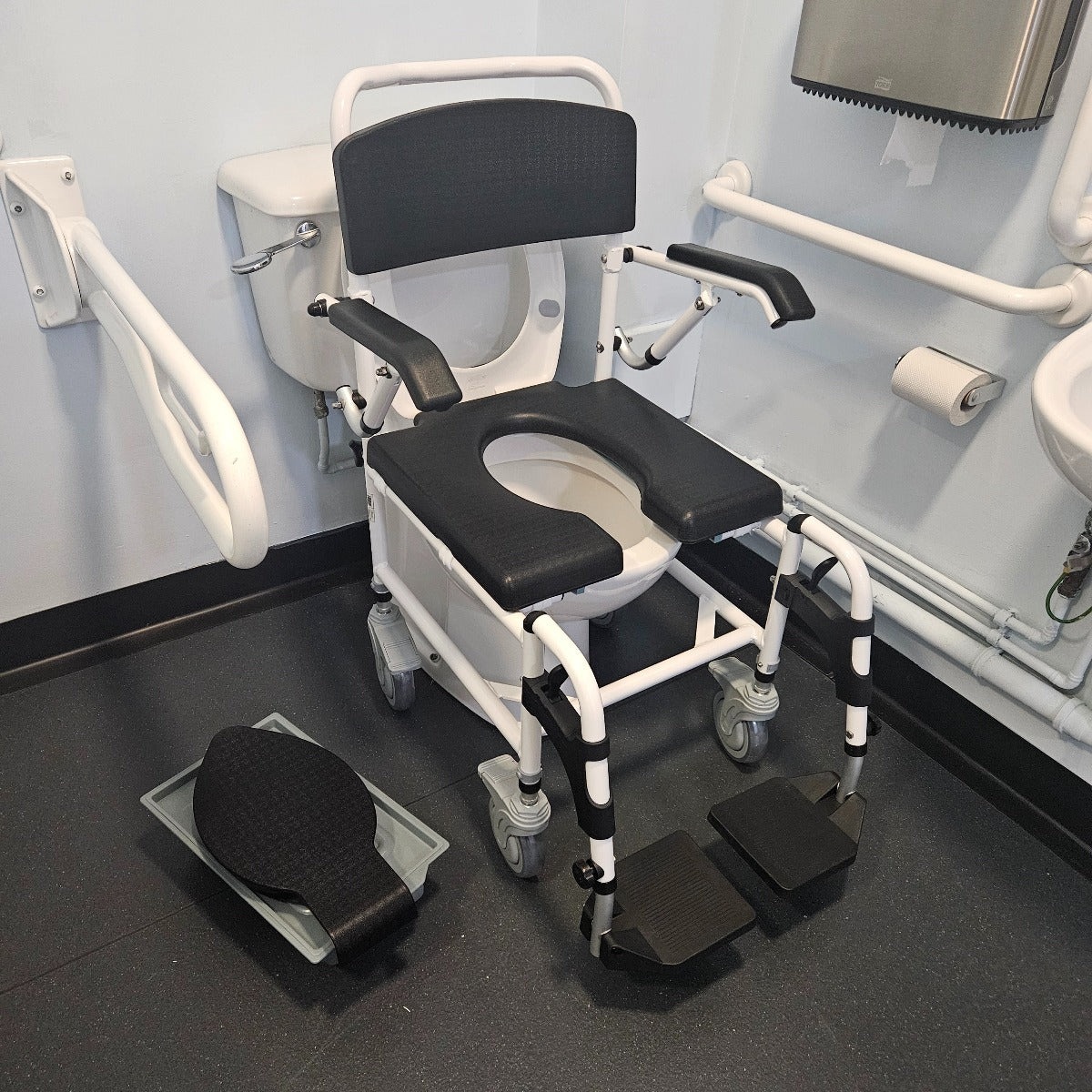 Attendant controlled wheeled shower commode chair