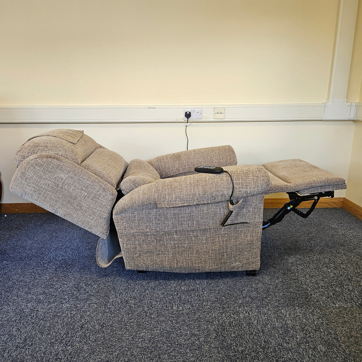 riser recliner on a carpeted floor against a white wall