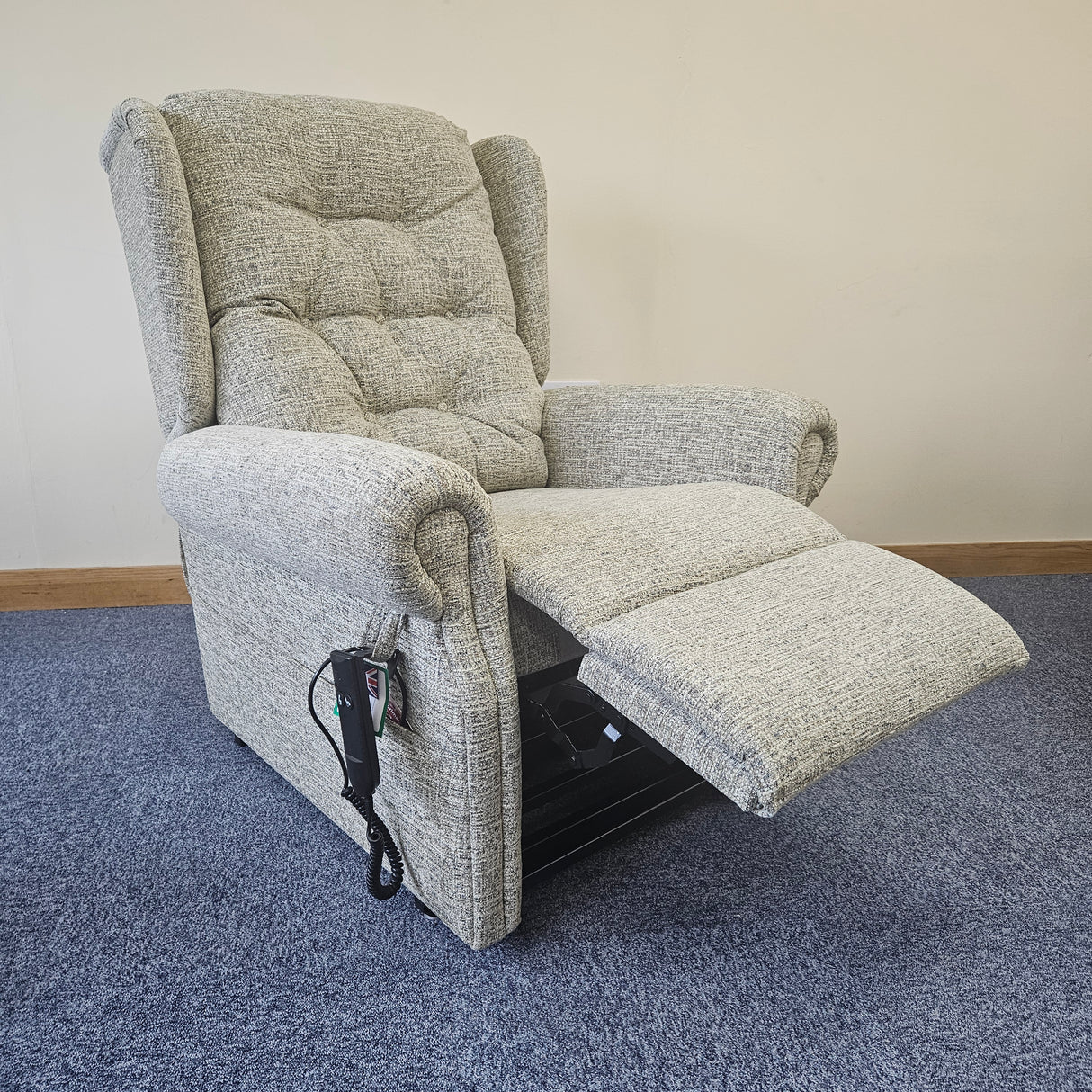 Gray recliner chair on a carpeted floor.