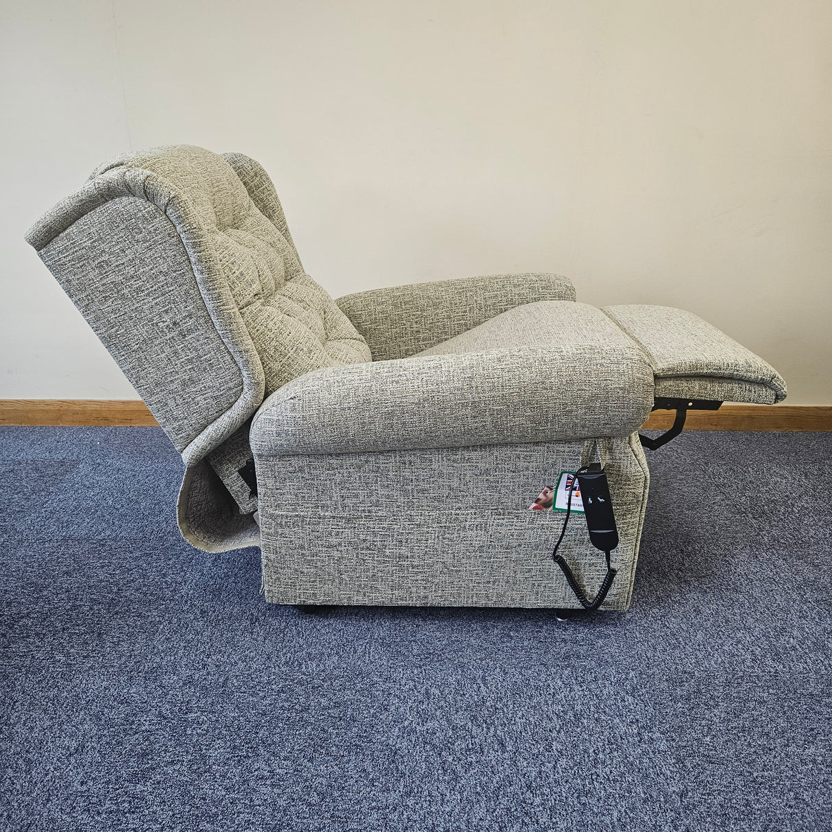 grey riser recliner chair on top of blue carpet floor