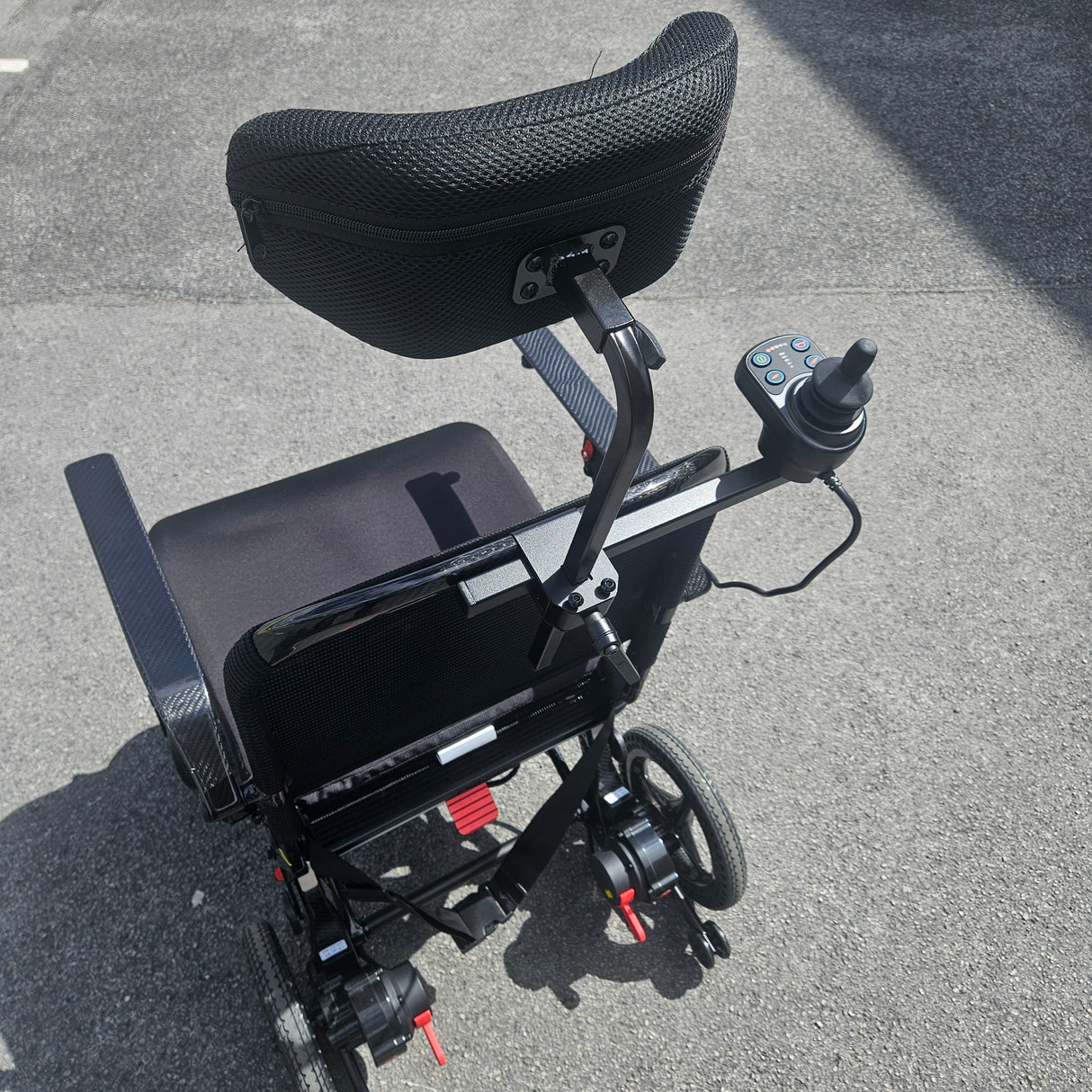 Black electric wheelchair on a gray pavement