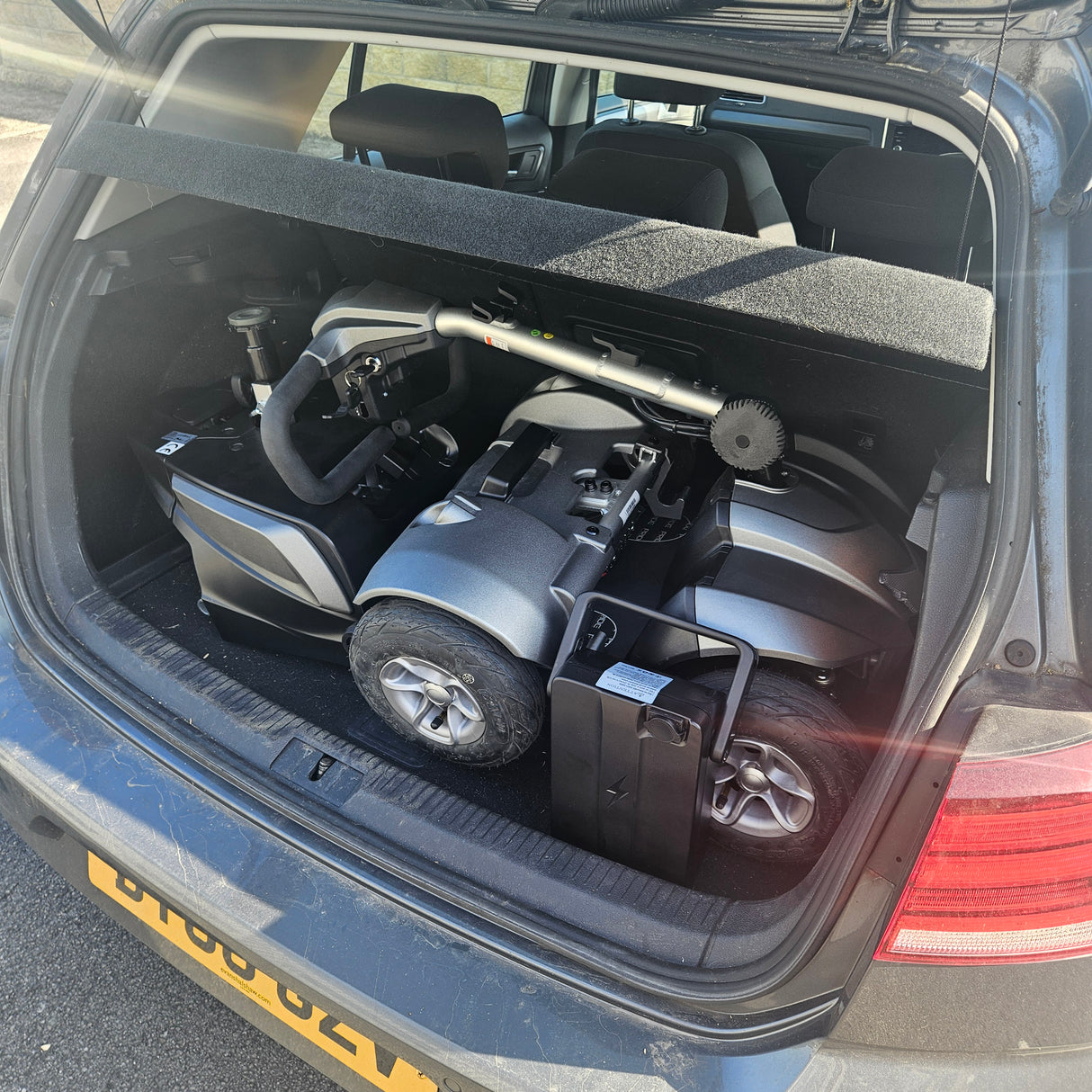 Electric mobility scooter inside a car boot
