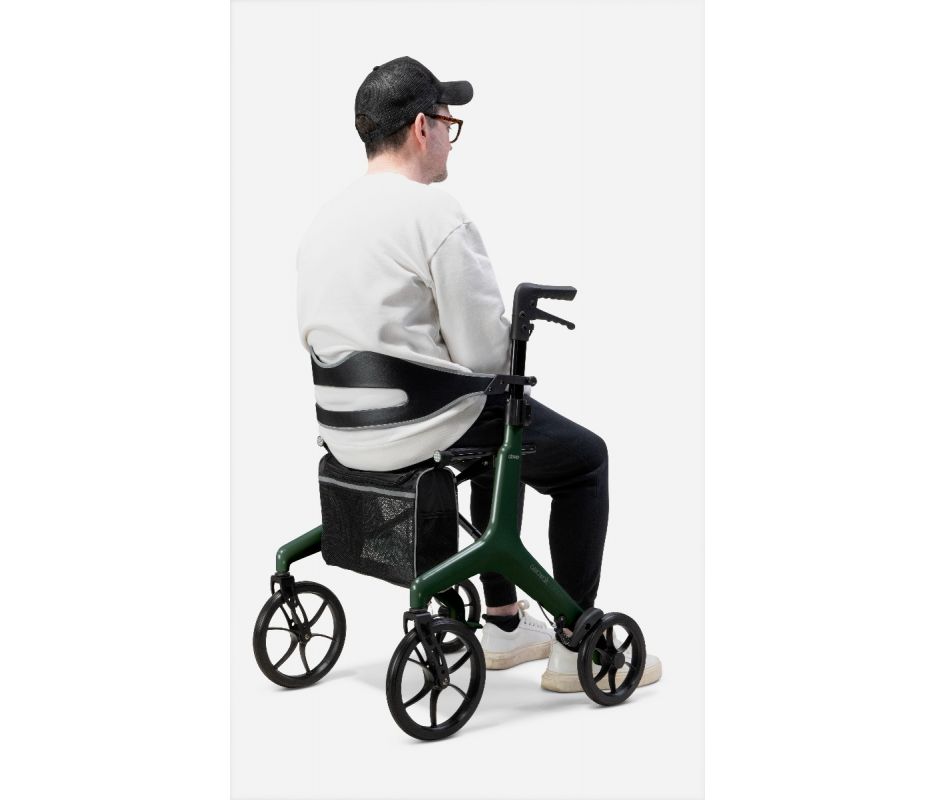Person using a green rollator with a seat on a white background