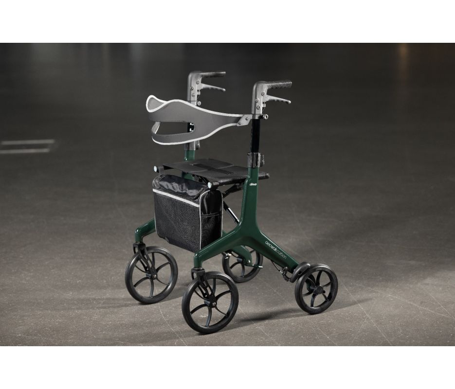 Green rollator with a gray bag on a dark floor