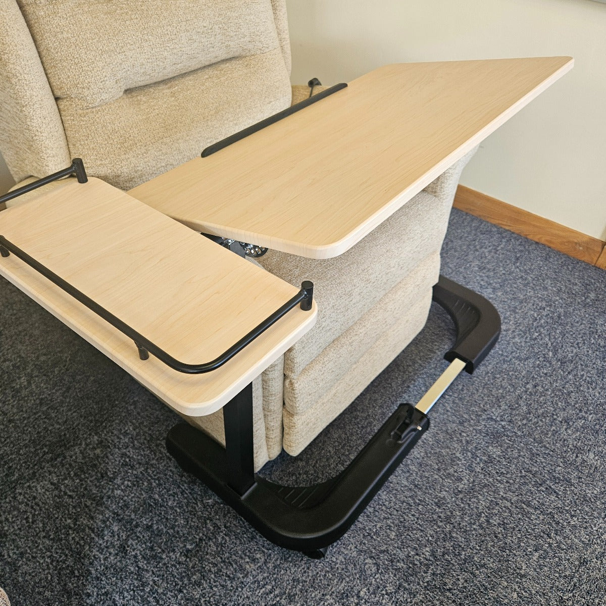 Portable lap desk attached to a recliner chair on a carpeted floor.