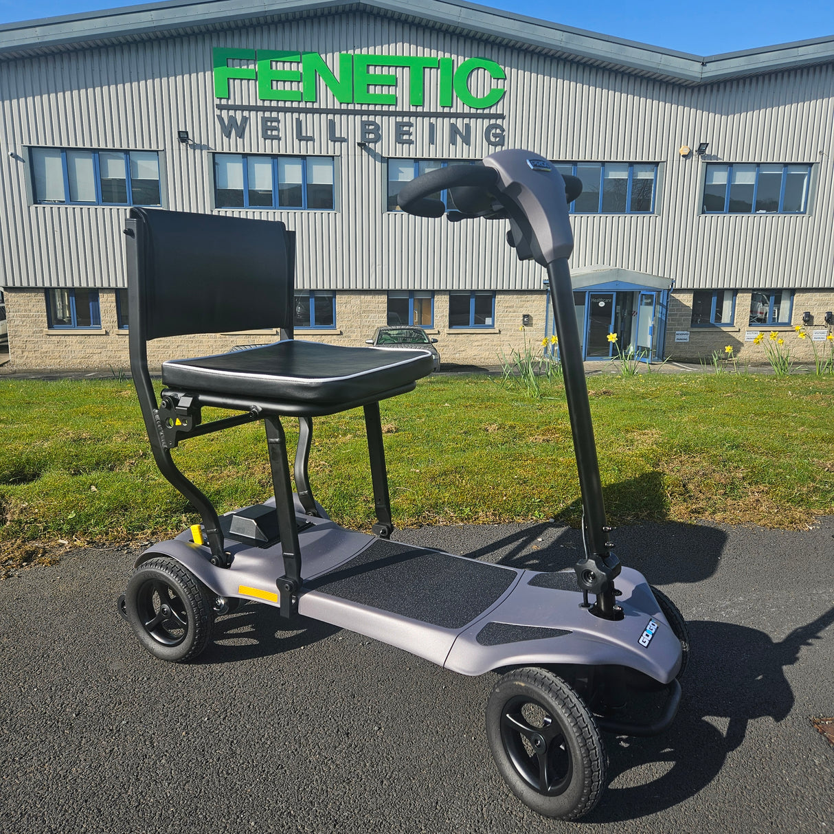 Electric scooter on a driveway with a building in the background