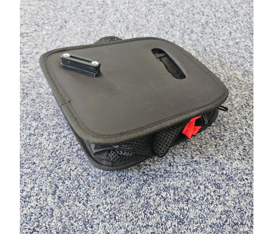 Black rollator bag on a textured gray surface