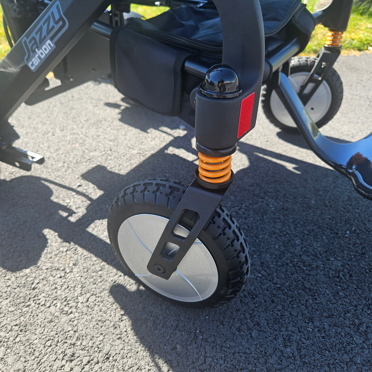 Close-up of a scooter wheel on a paved surface