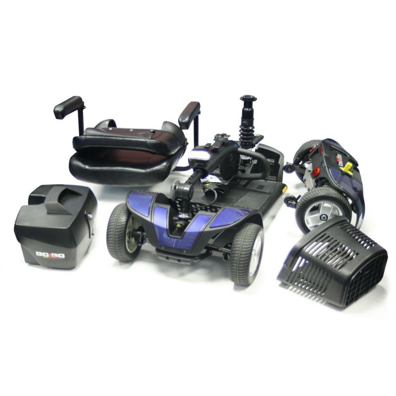 Components of a collapsible wheelchair, including wheels, cushions, and frame, neatly arranged on a green mat with branding.