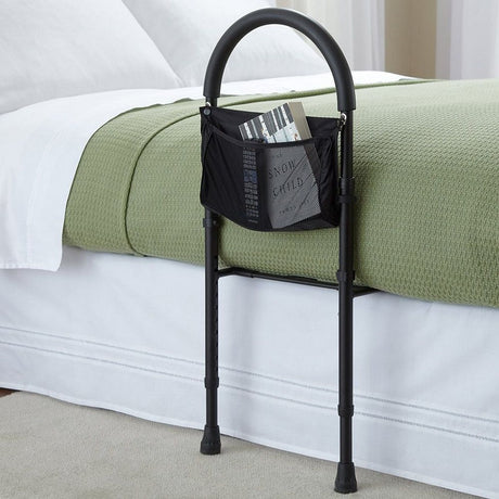 Black adjustable bed rail with built-in storage pouch, designed as a safety support and convenience solution under the category of home aids for elderly.