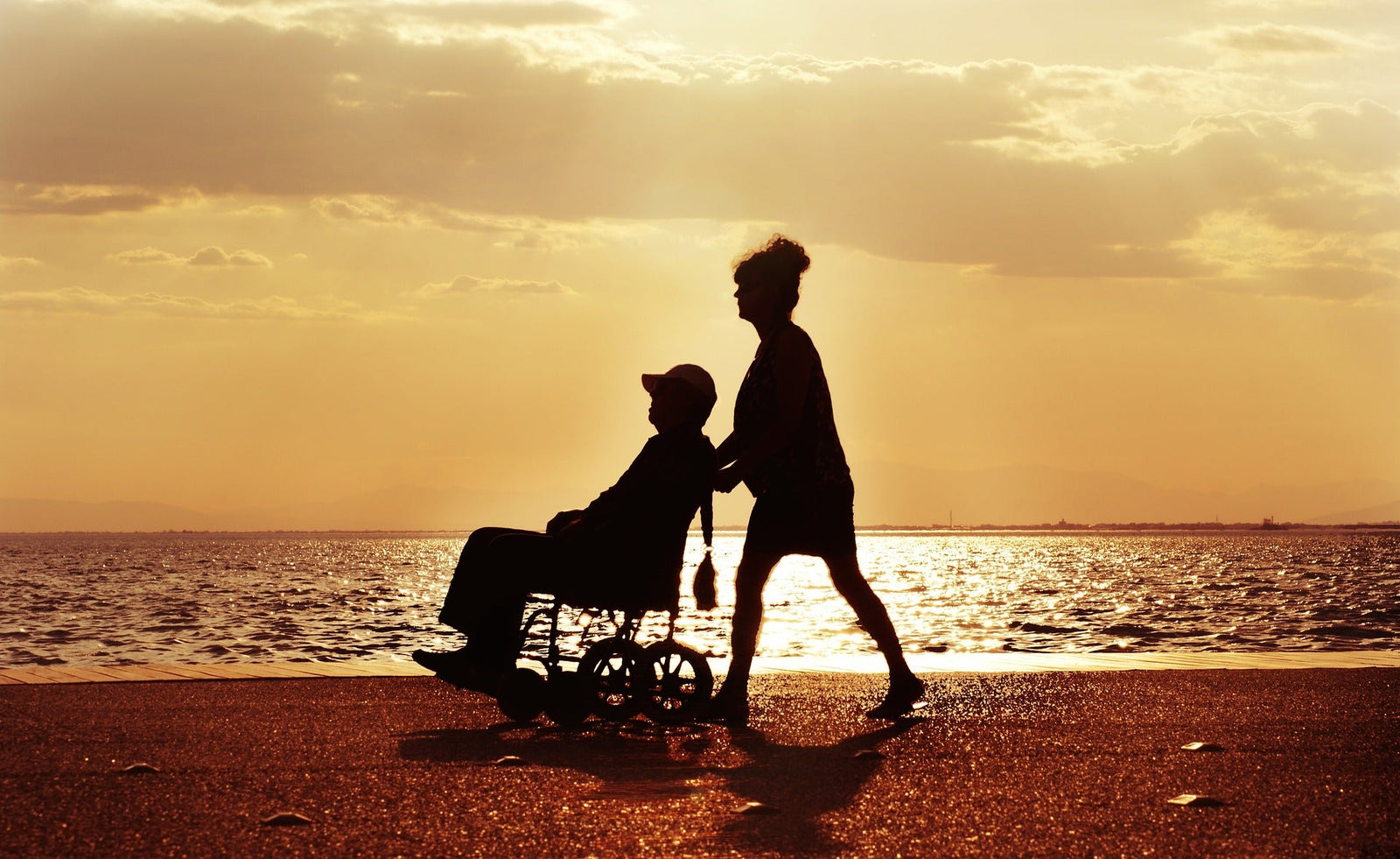 Couple at the beach with wheelchair