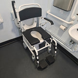 Attendant controlled wheeled shower commode chair