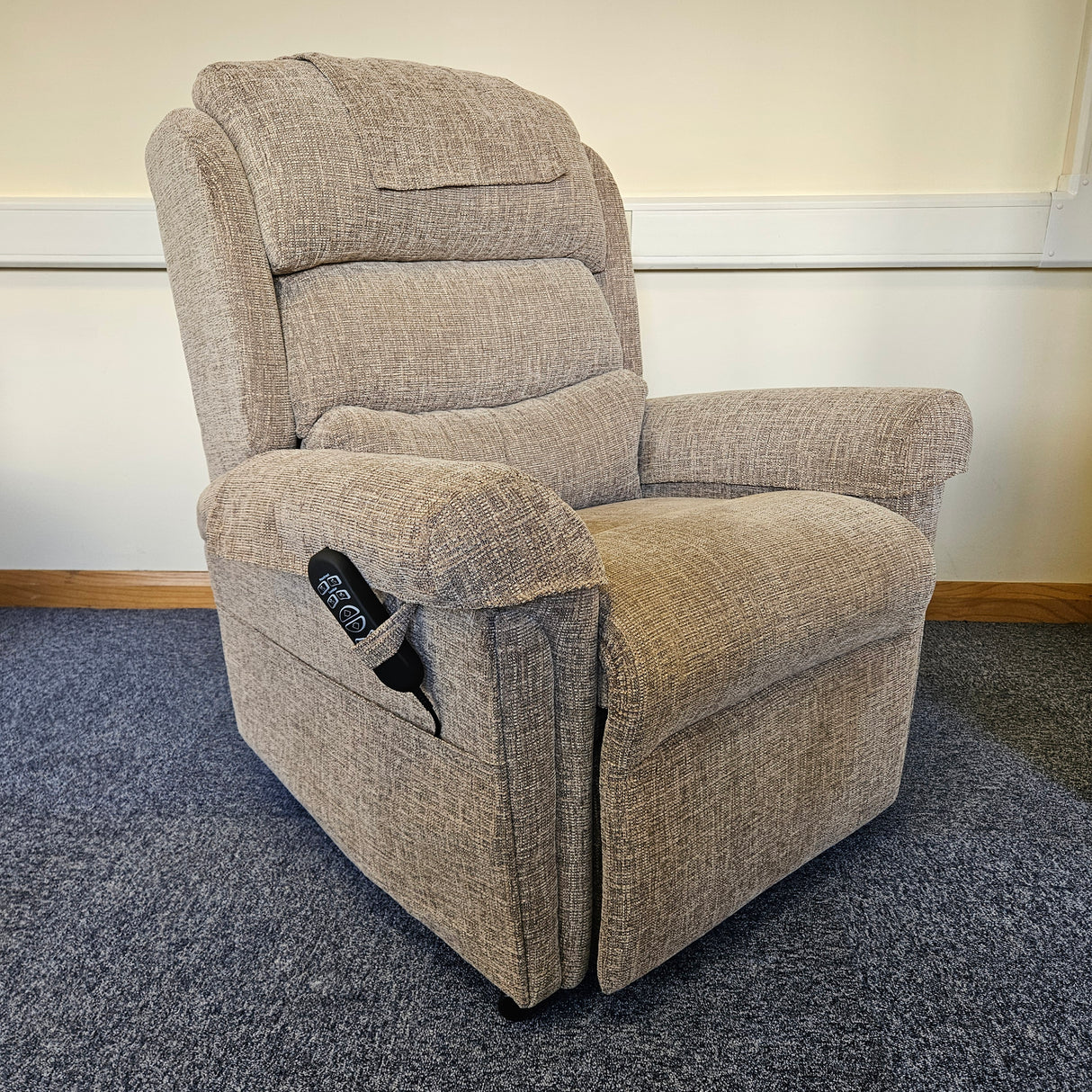 Gray recliner chair against a neutral wall