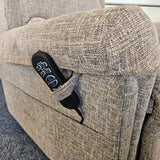 Control panel of a gray recliner chair with visible buttons.