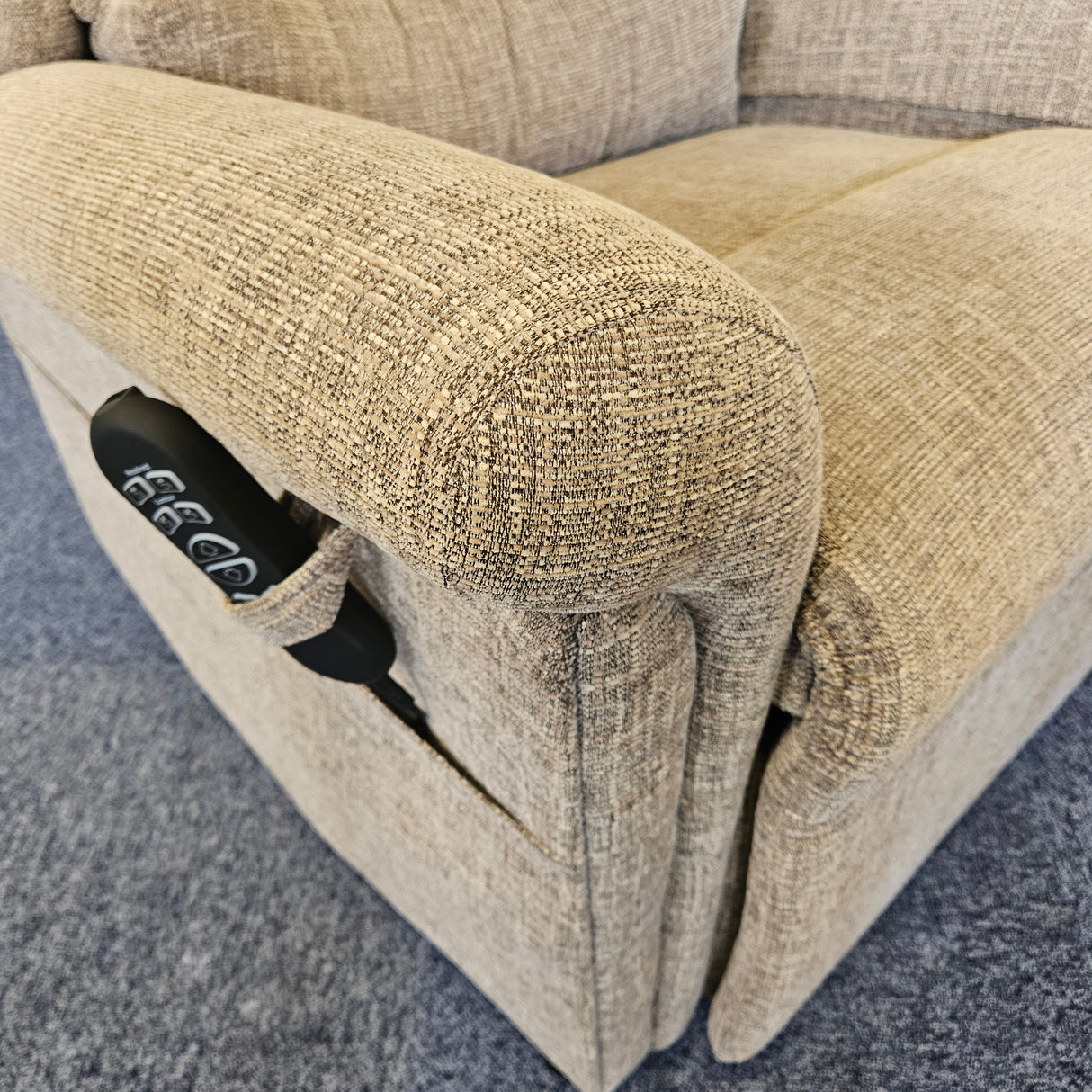 close up riser recliner, showcasing the remote.
