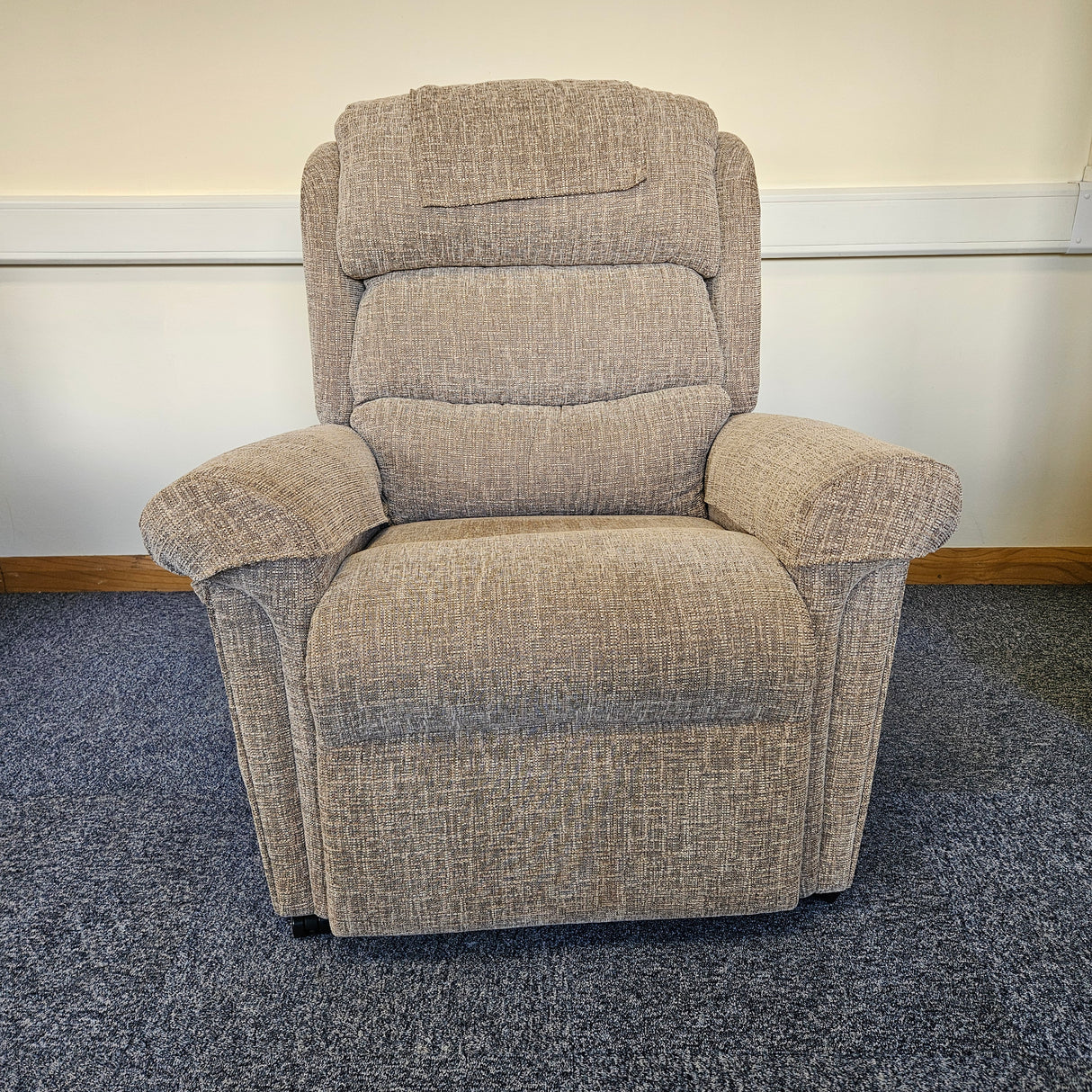 Gray recliner chair on a carpeted floor