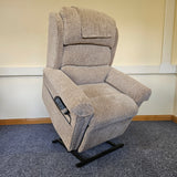 Gray recliner chair with remote control on a carpeted floor.