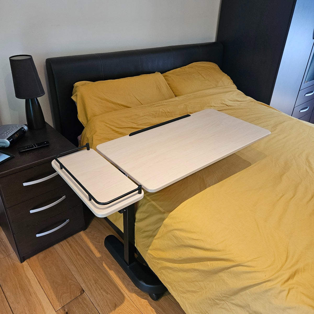 desk attached to a bed with yellow bedding in a bedroom setting.