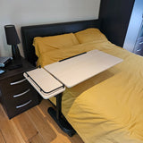 desk attached to a bed with yellow bedding in a bedroom setting.