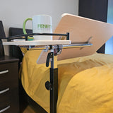 Bedside table with a cup labelled 'Fenetic' on a bed with yellow sheets.