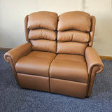 Brown leather sofa on a blue carpet with a white wall background