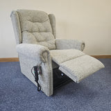 Gray recliner chair on a carpeted floor.