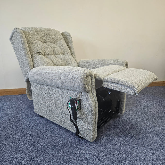 Gray recliner chair with armrests on a carpeted floor.