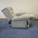 grey riser recliner chair on top of blue carpet floor