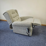 Gray riser recliner chair on a blue carpet