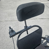 Black mesh chair with control panel on a concrete surface