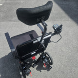 Black electric wheelchair on a gray pavement