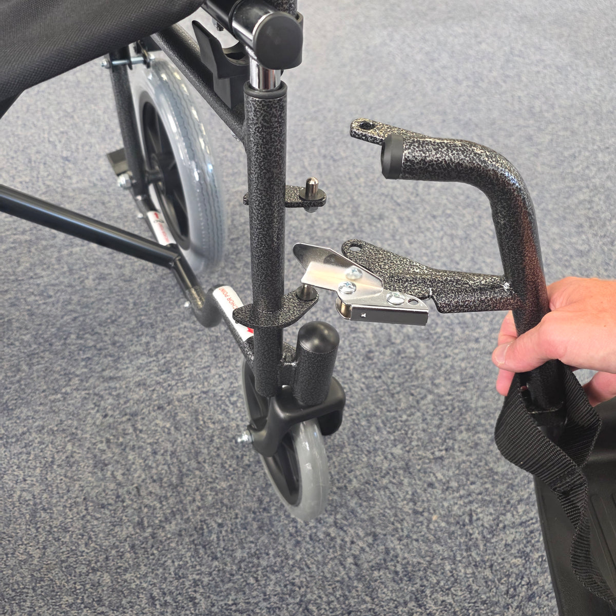 Crash tested wheelchair- Carer controlled suitable for use in a vehicle
