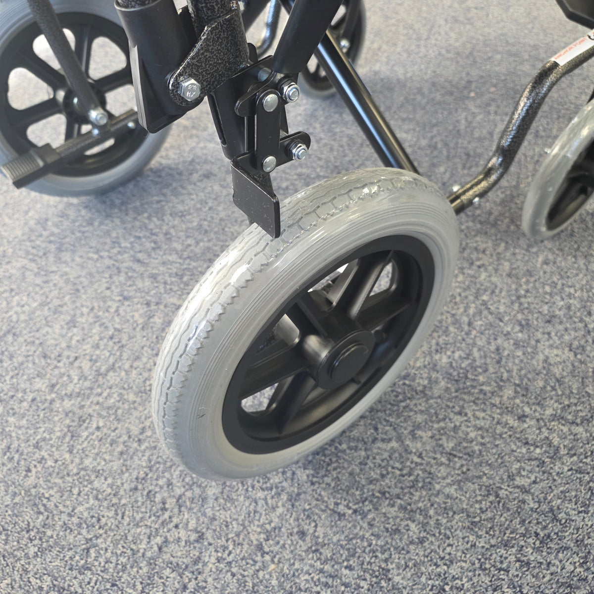 Crash tested wheelchair- Carer controlled suitable for use in a vehicle
