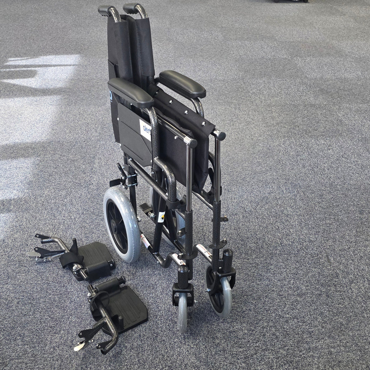 Crash tested wheelchair- Carer controlled suitable for use in a vehicle