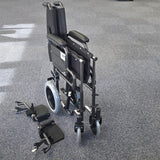 Crash tested wheelchair- Carer controlled suitable for use in a vehicle