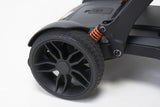 Close-up of a wheel and suspension system on a mobility scooter
