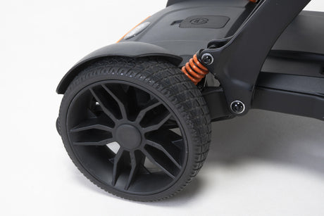 Close-up of a wheel and suspension system on a mobility scooter
