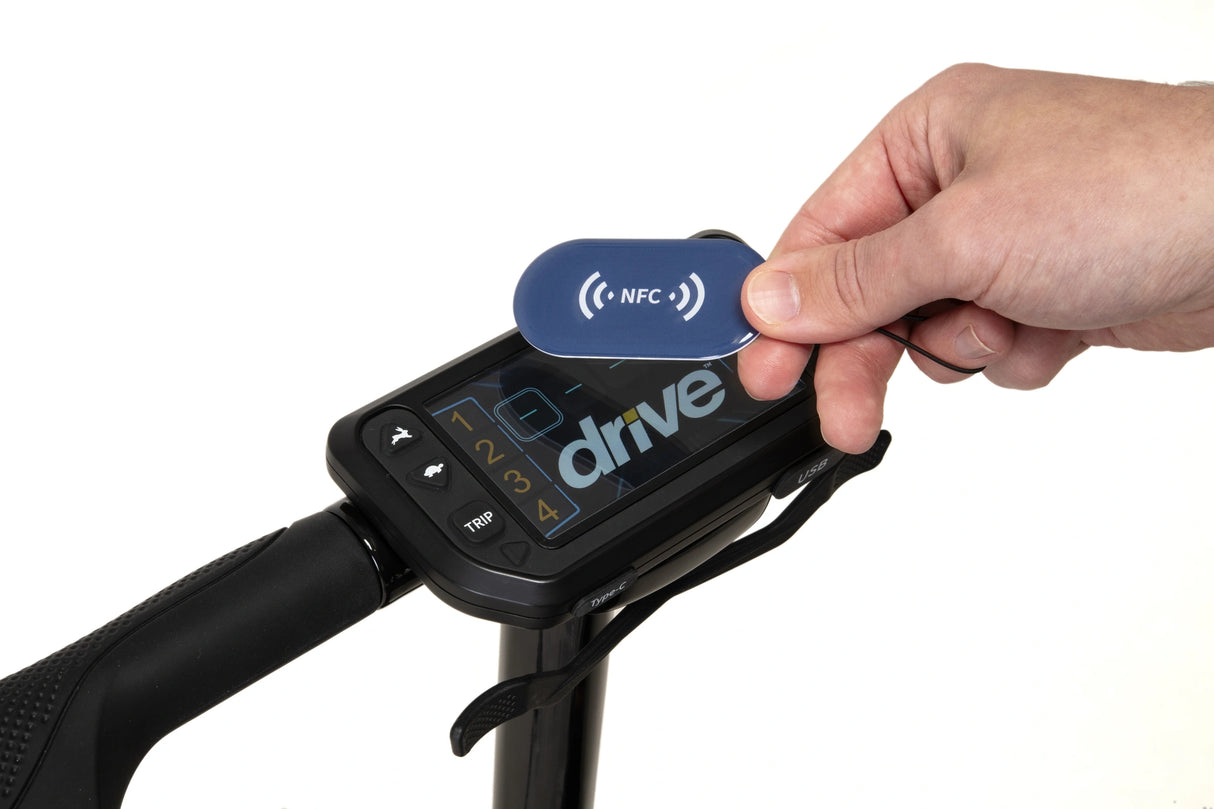 Hand holding a blue NFC tag near a device with 'drive' branding on a white background