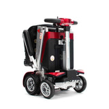 Red and black folded mobility scooter on a white background