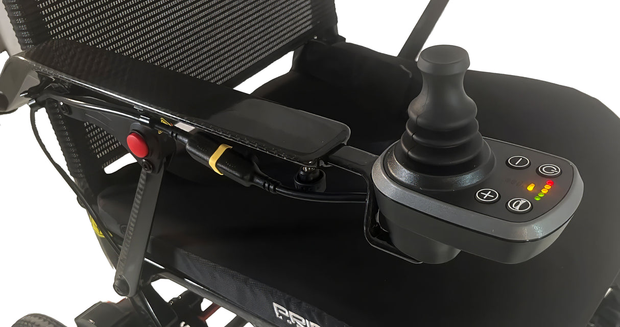 Control panel of a power wheelchair with joystick and buttons on a white background