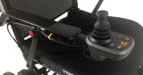 Control panel of a power wheelchair with joystick and buttons on a white background