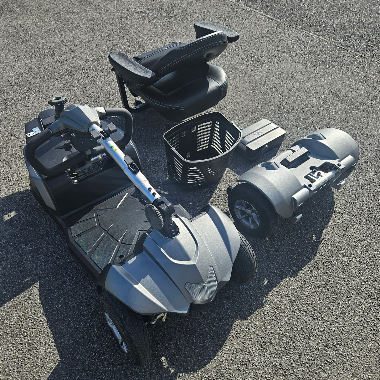 Top-down view of a mobility scooter on a concrete surface