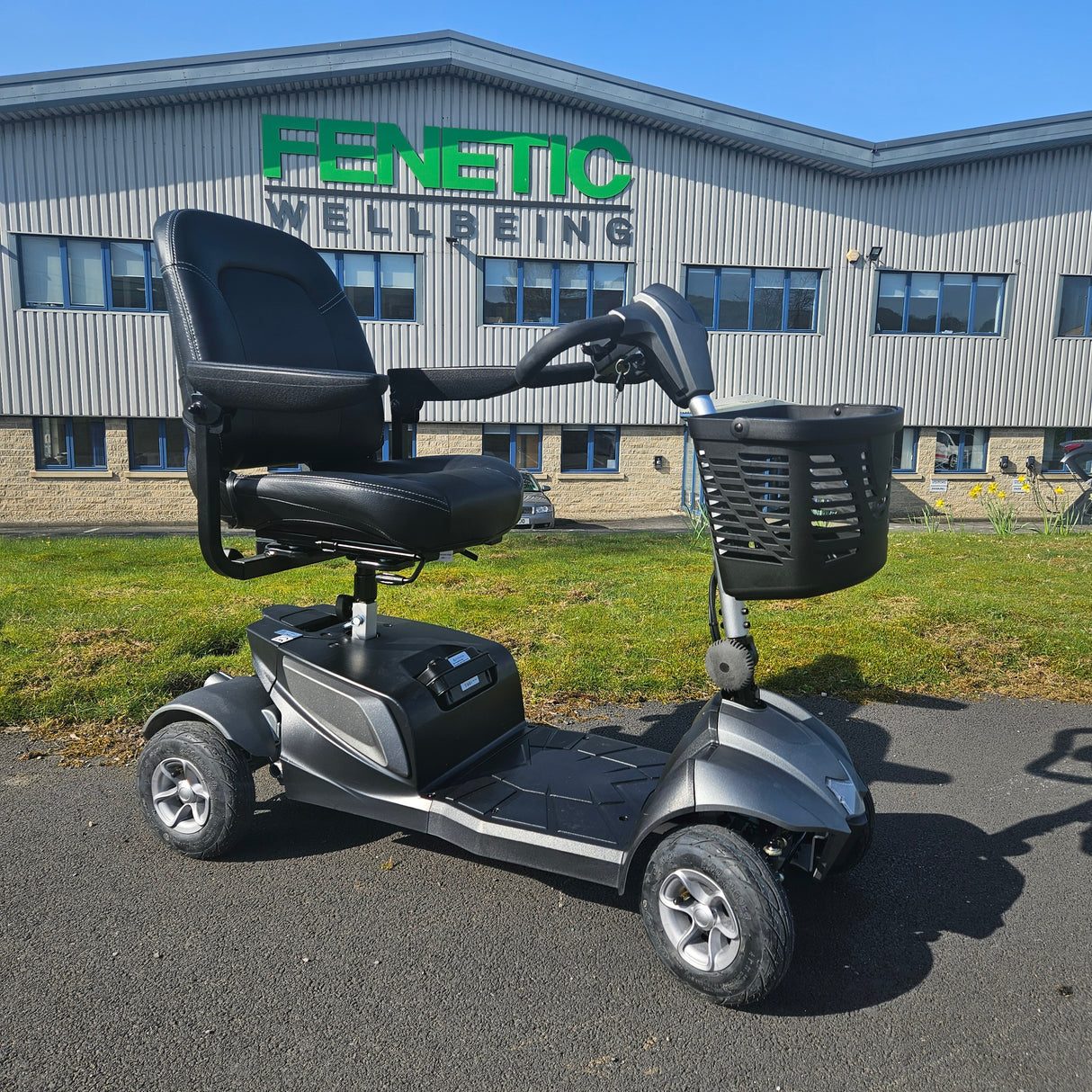  mobility scooter on a paved area with a building in the background