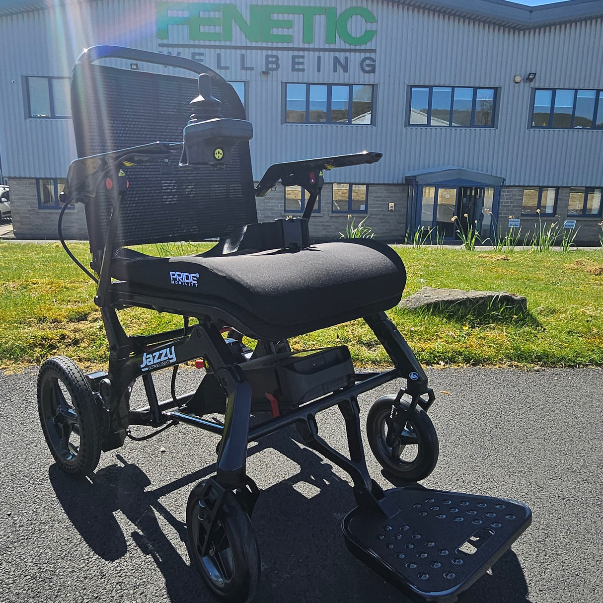 Electric wheelchair on a street with a building in the background