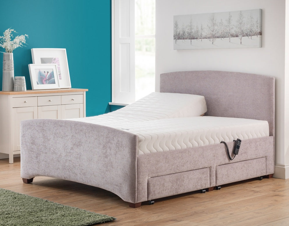 Gray upholstered bed in a room with a blue wall and window.