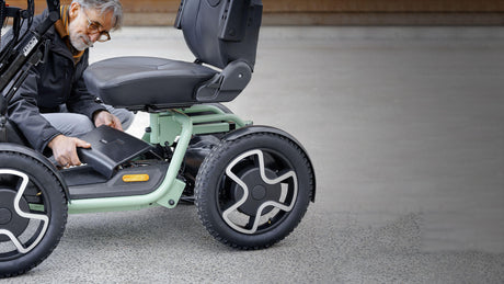Person using a modern electric mobility scooter on a concrete surface