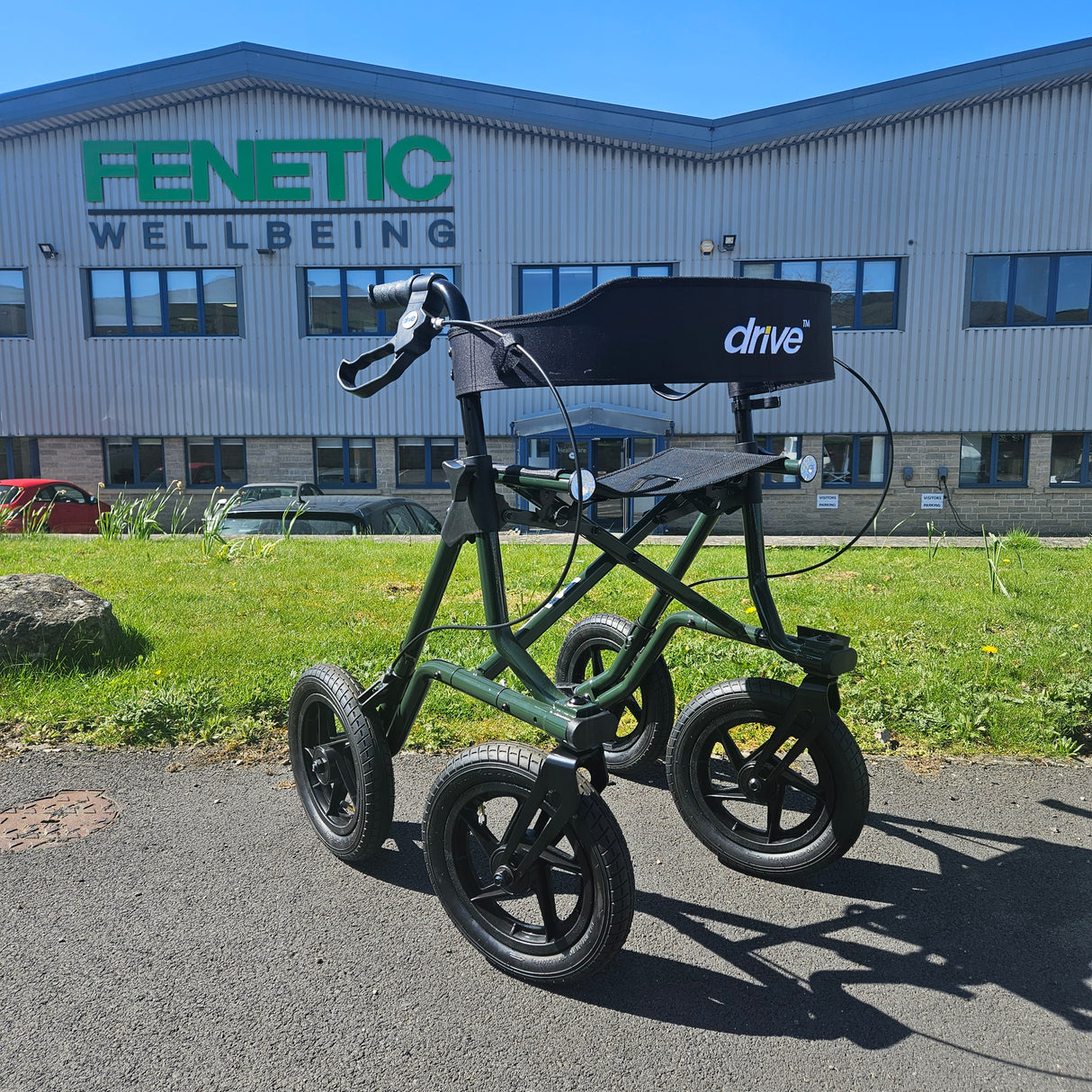 green rollator in front of a building with 'Fenetic Wellbeing' signage.