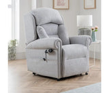 Gray recliner chair in a living room setting with light wood flooring and white walls.