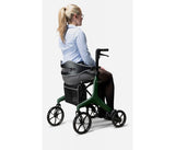 Person using a green rollator on a white background