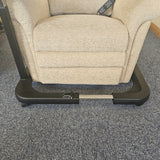 Beige recliner chair with a footrest on a gray carpet